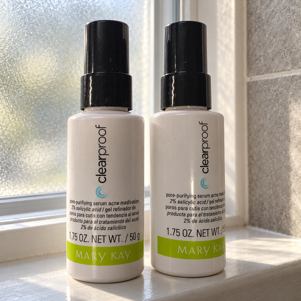 Styled lifestyle image of two Mary Kay Clear Proof Pore-Purifying Serum 1.75 oz bottles in a window sill setting; props not included