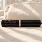 Mary Kay Dark Blonde brow tint beside a cream cotton makeup pouch