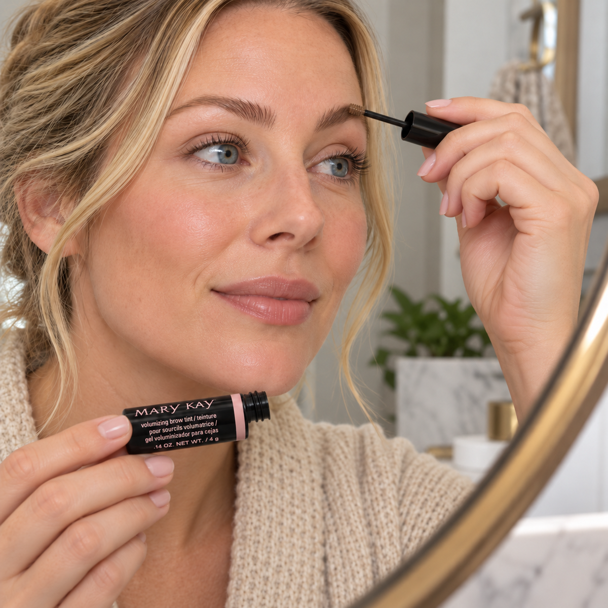 Adult grooming her eyebrow with Mary Kay Dark Blonde Brow Tint