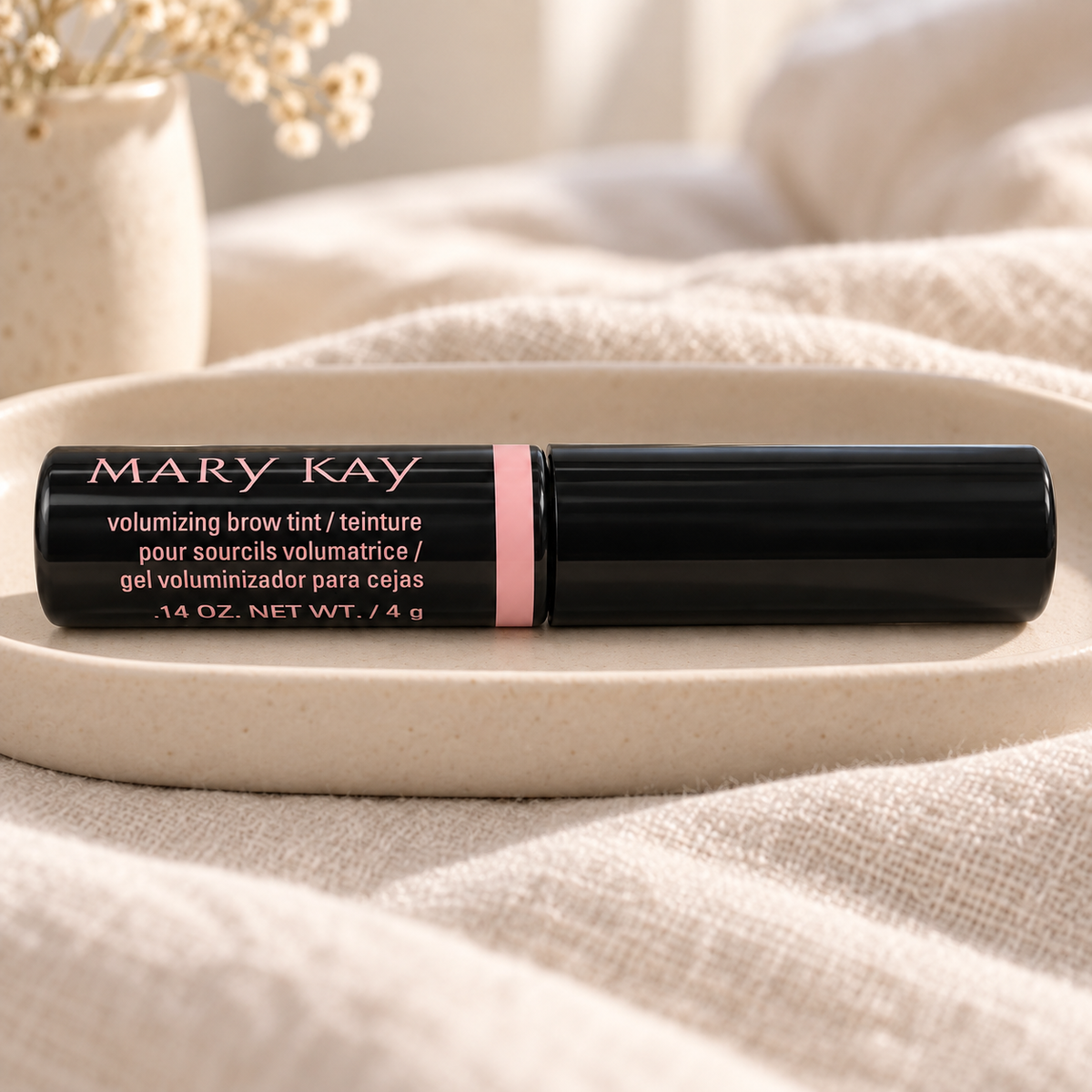 Mary Kay Dark Blonde brow tint on a cream ceramic tray with linen