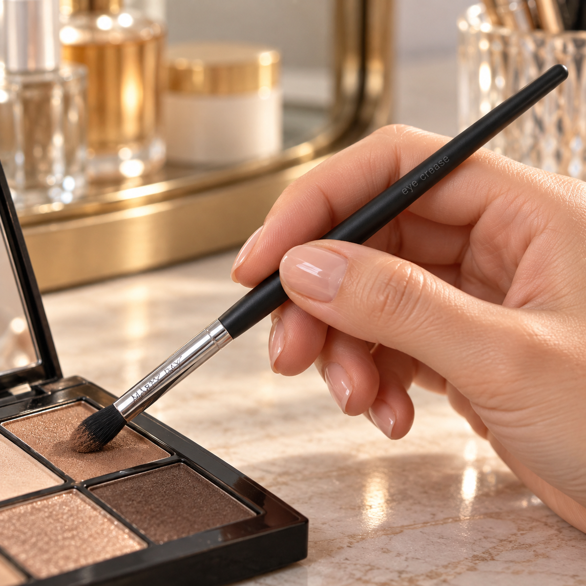 Mary Kay Eye Crease Brush picking up powder eye shadow from a palette.