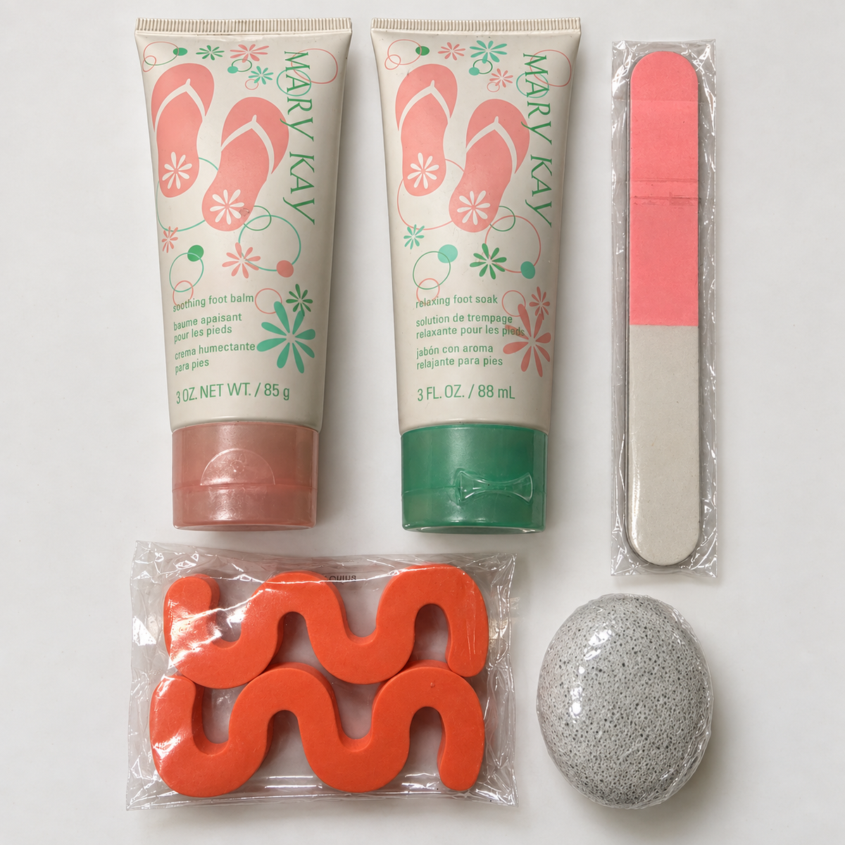 Complete Mary Kay foot-care bundle with 3 oz balm, 3 fl oz soak, nail file, two orange toe separators and sealed gray pumice stone