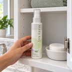 Mary Kay Botanical Effects Freshen Formula 3 capped bottle being returned to a bathroom shelf beside cotton pads