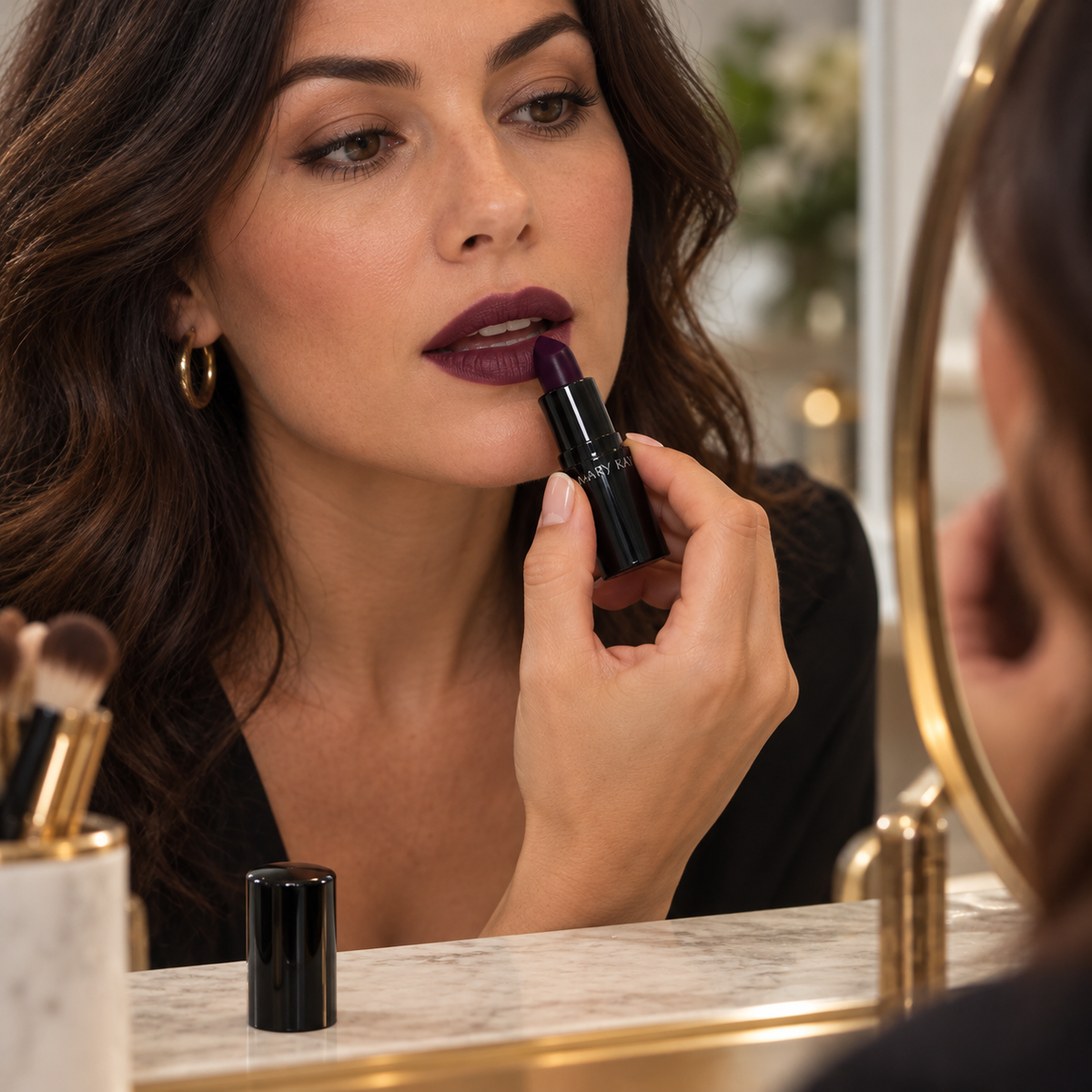 Adult applying Mary Kay Puro Mirtillo matte lipstick