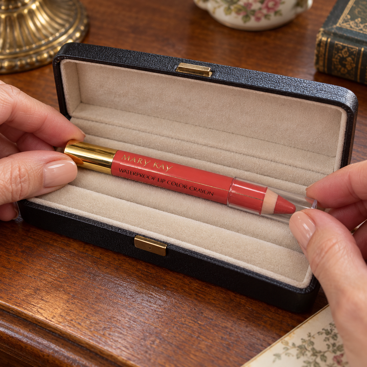 Placing the capped Mary Kay Peach Blossom crayon in a padded display case