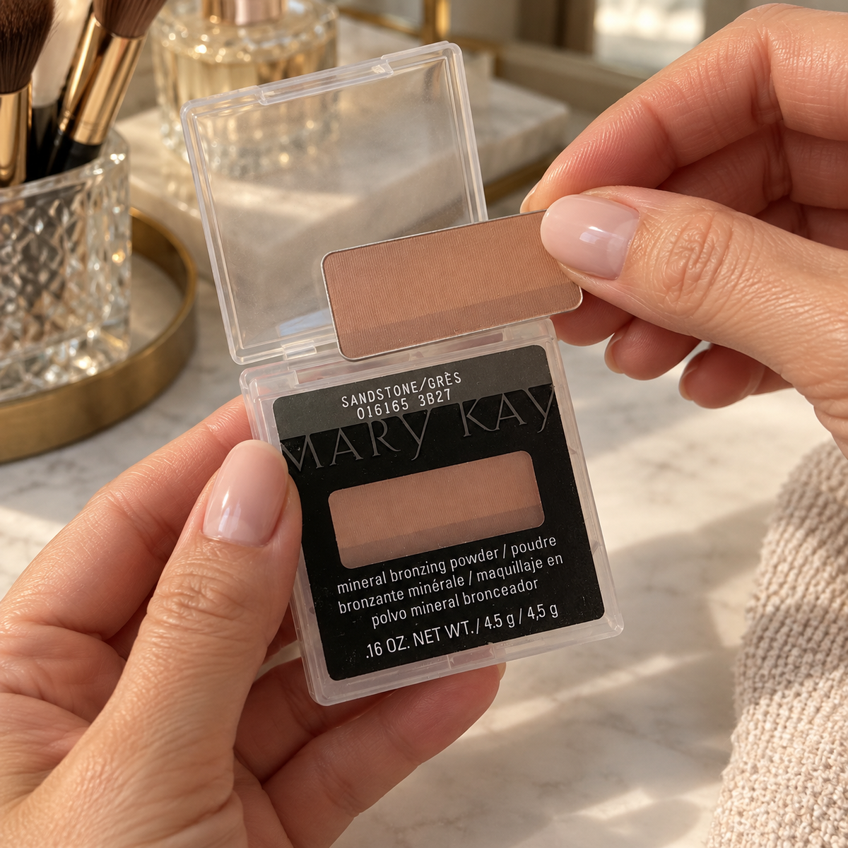 Opening the protective case around Mary Kay Sandstone bronzing powder