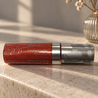 Mary Kay Tropical Spice Lip Crème on a light stone console