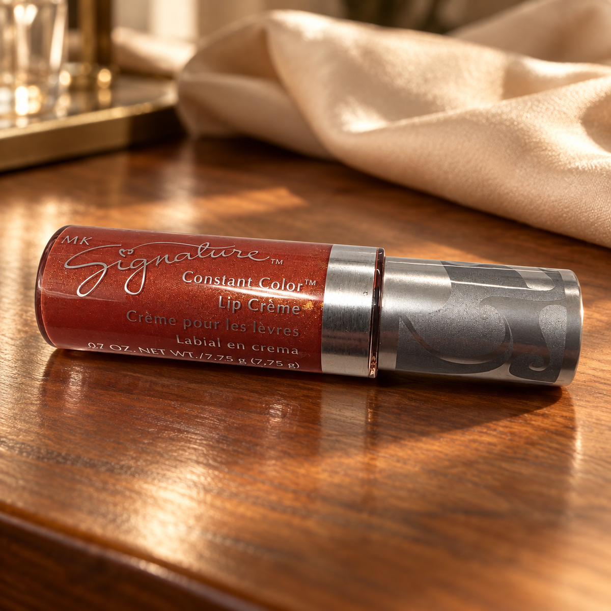 Mary Kay Tropical Spice Lip Crème on a warm walnut vanity