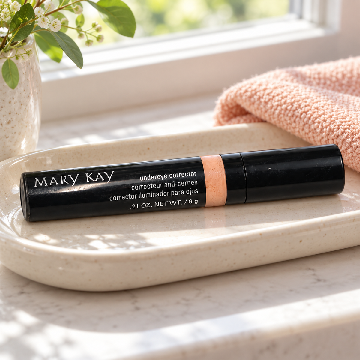 Mary Kay Undereye Corrector on a cream ceramic tray by a window