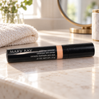 Mary Kay Undereye Corrector on a light vanity beside a folded towel and mirror