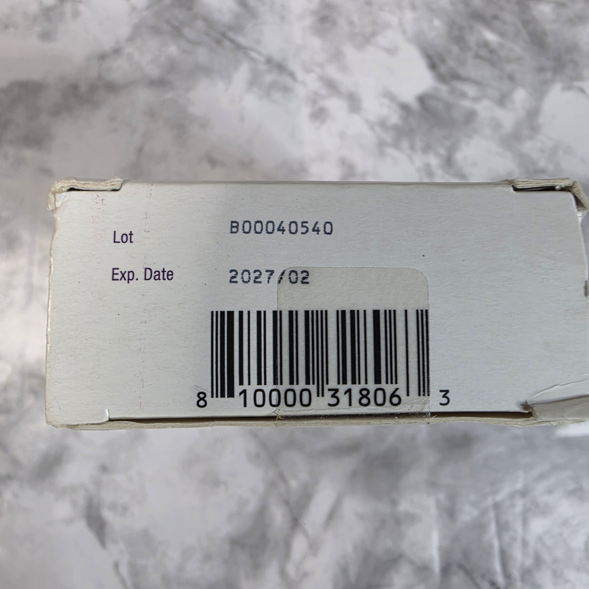 Actual Mederma Scar Cream plus SPF 30 carton end showing February 2027 expiration and UPC