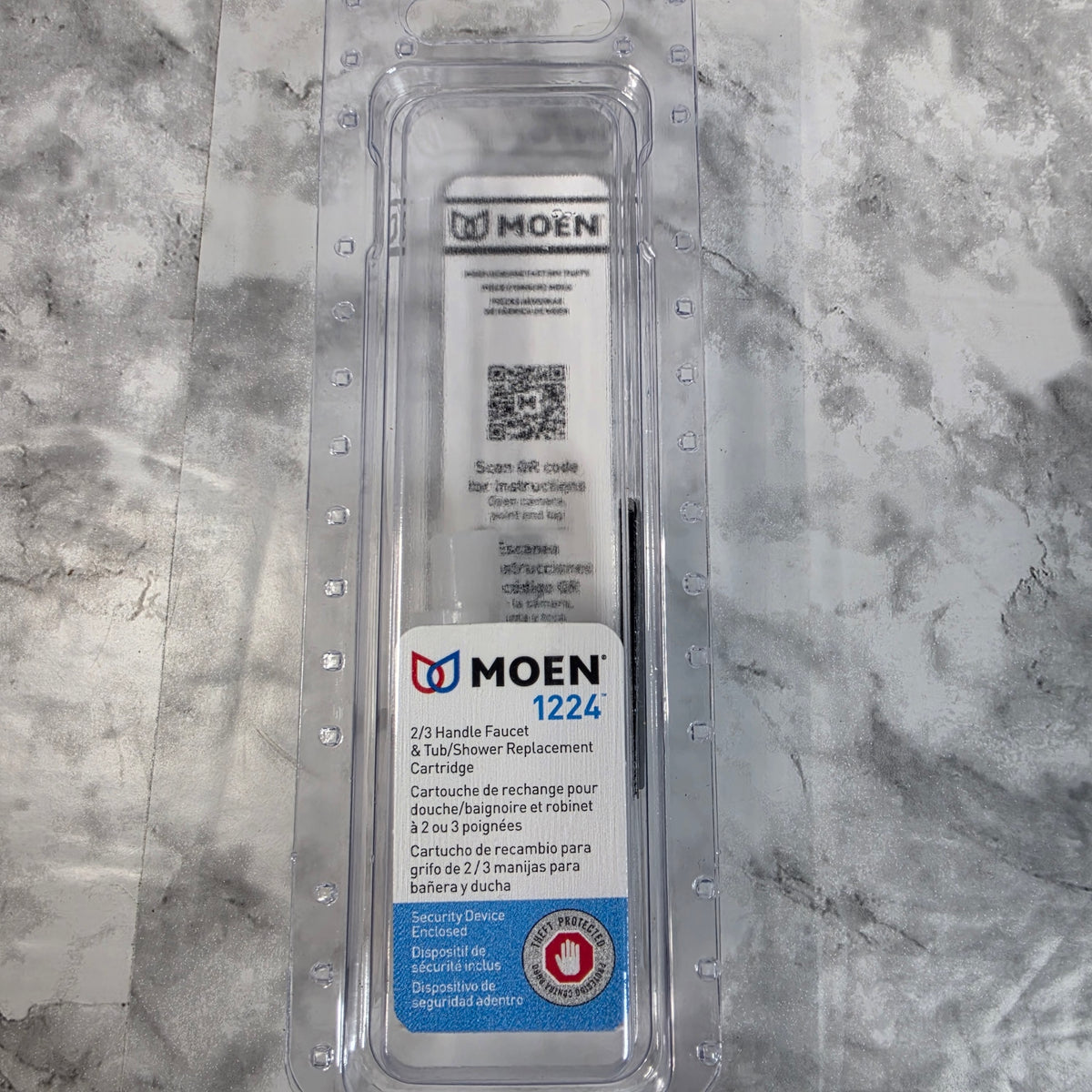 Actual More4less inventory photo of the Moen 1224 two- or three-handle faucet and tub/shower replacement cartridge in its original package.