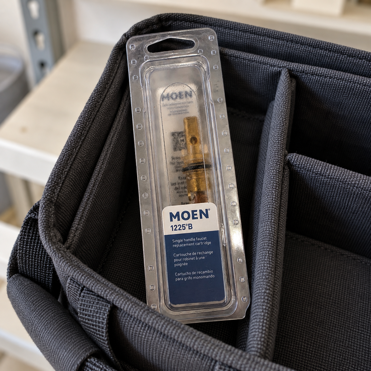 Packaged Moen 1225B replacement cartridge in an open fabric repair tote.