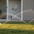 AI-generated lifestyle context of the Moen WICNT008G1USA controller indoors with residential lawn irrigation outside; not the actual stocked item.