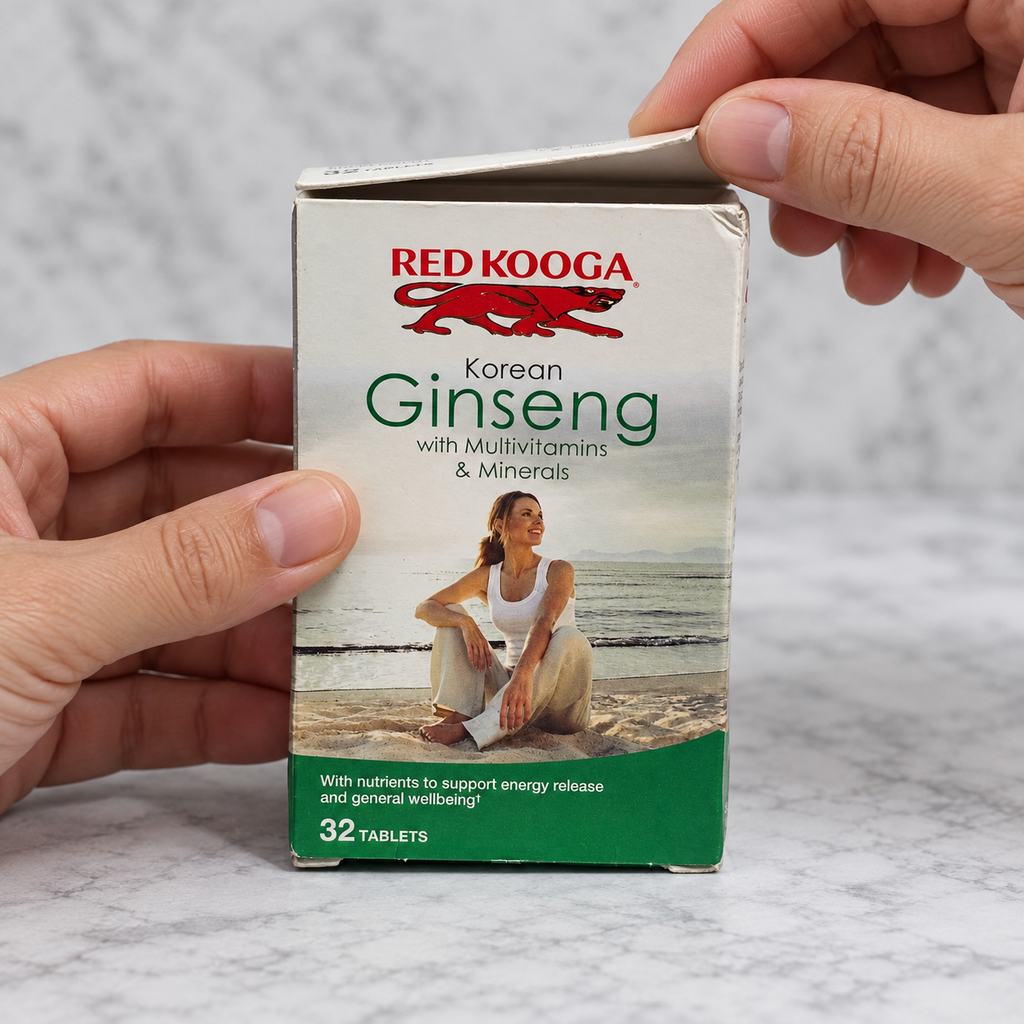 Adult hands lift the top flap of the older Red Kooga Korean Ginseng with Multivitamins & Minerals 32-tablet carton, keeping the contents concealed.