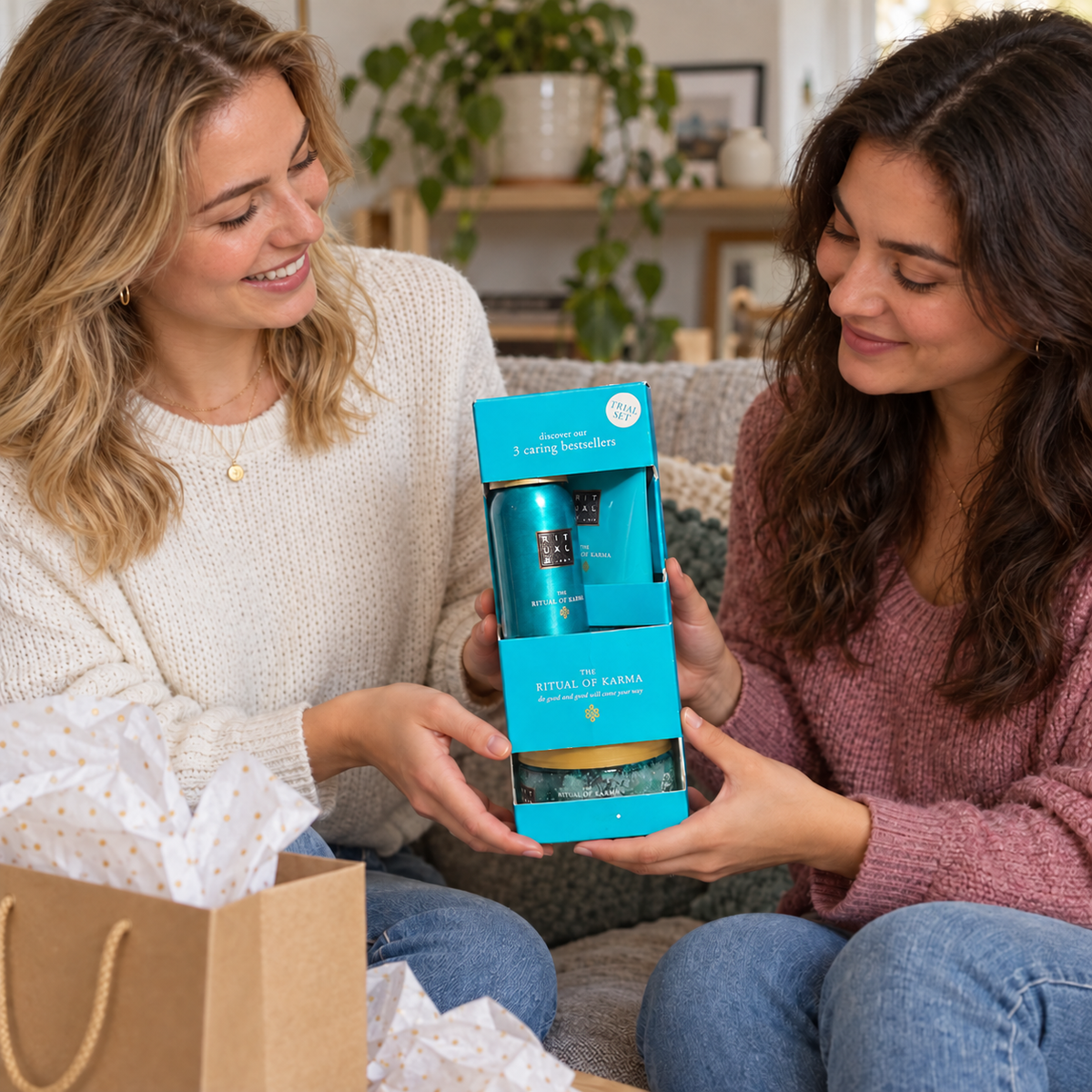 Two adults exchanging a boxed Rituals The Ritual of Karma three-piece trial set as a gift