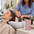 Stylist smoothing an adult client’s damp hair lengths beside KEVIN.MURPHY ANGEL.RINSE 250 mL