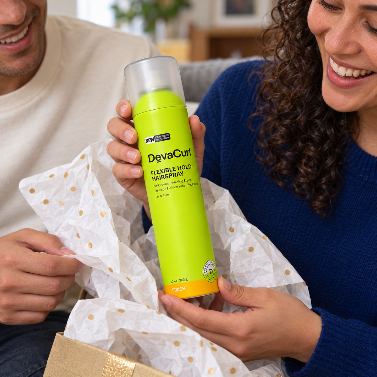 Adult unwrapping one capped DevaCurl Flexible Hold Hairspray 10 oz can as a gift