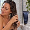 Adult working through wet hair during a MONAT Replenish Masque conditioning routine
