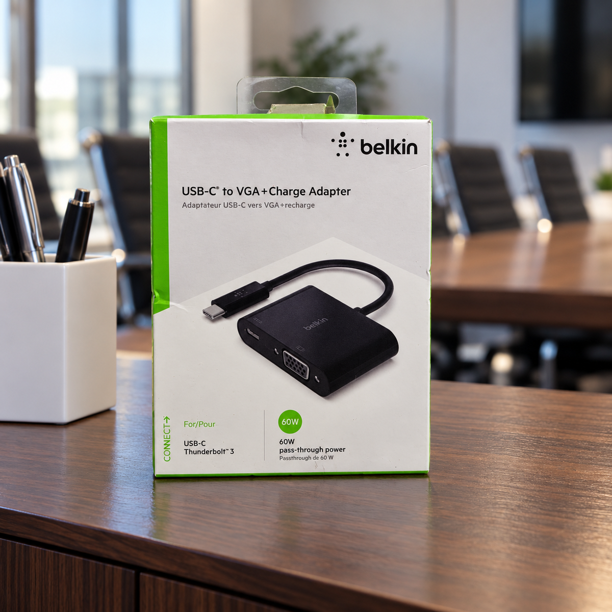 AI-generated lifestyle illustration of the Belkin AVC001 VGA + Charge Adapter retail box in a meeting room; background props not included