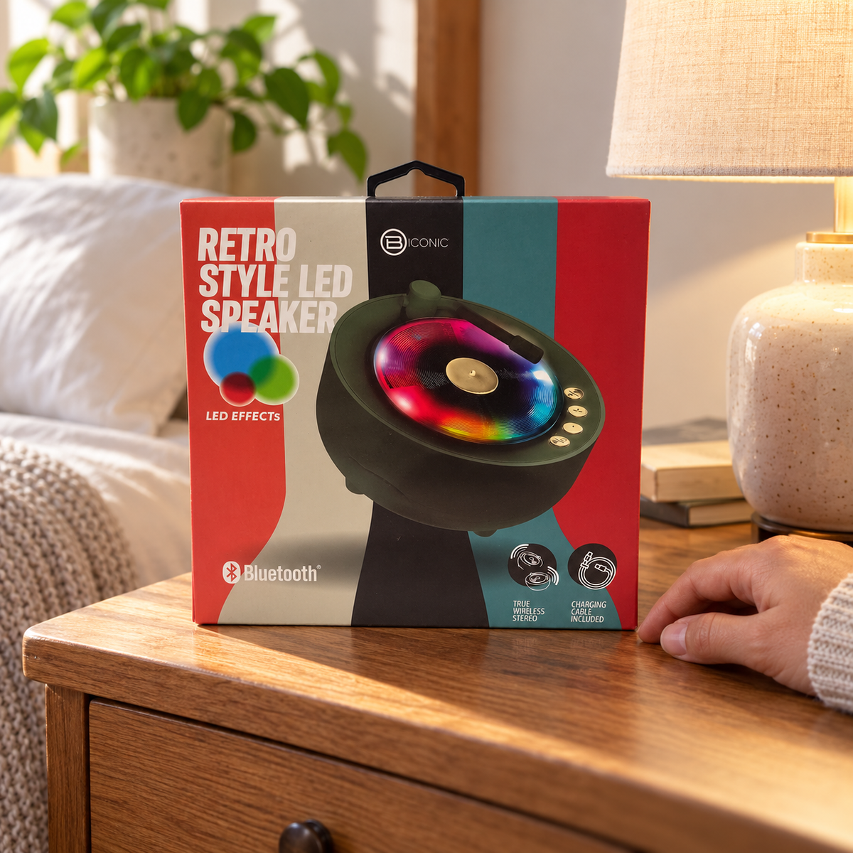 AI-generated scene of the same single BIconic Retro Style LED Speaker carton on a bedside table; hand and room props excluded.