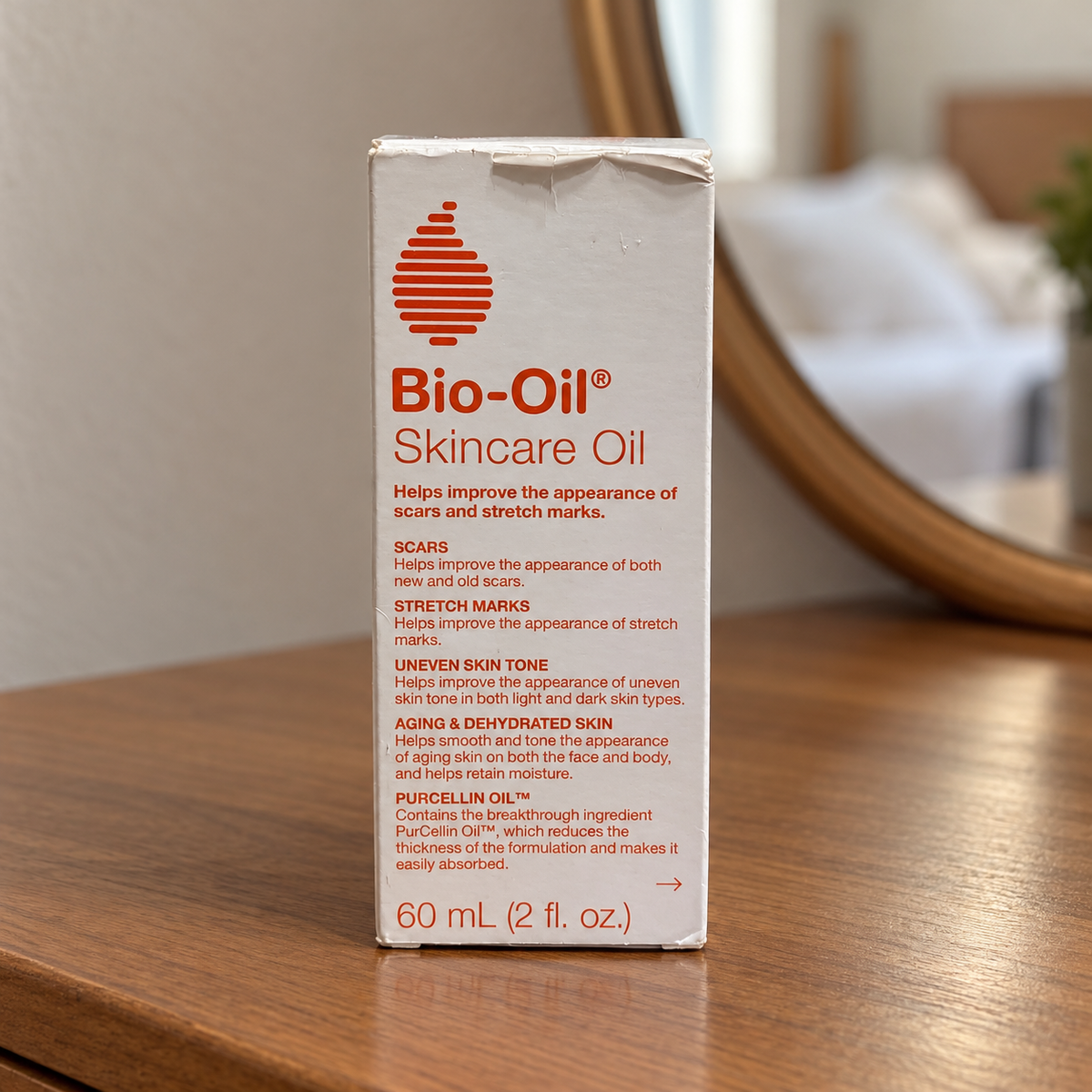 AI-generated lifestyle illustration of the same Bio-Oil 60 mL retail carton with top creasing on a bedroom dresser; furnishings excluded.