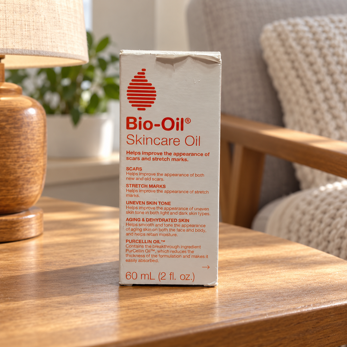 AI-generated lifestyle illustration of the same Bio-Oil 60 mL retail carton with top creasing on a bedside table; room props excluded.