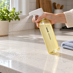 Blueland Multi-Surface Cleaner being sprayed onto a sealed kitchen countertop