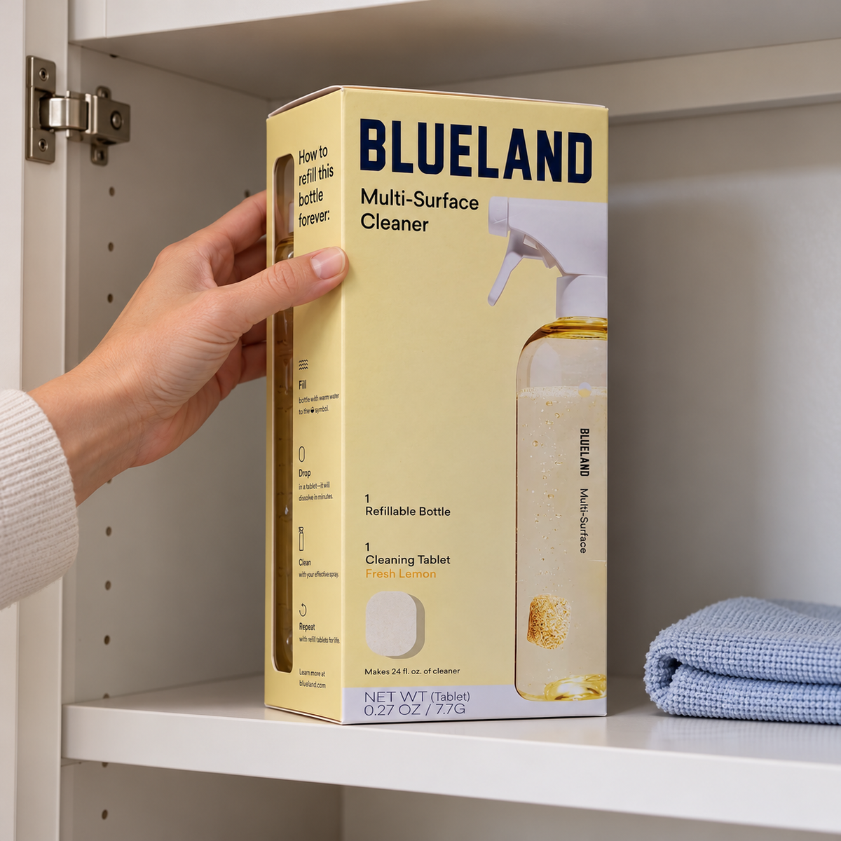 Blueland Multi-Surface Cleaner starter-set carton being placed on a dry utility cupboard shelf