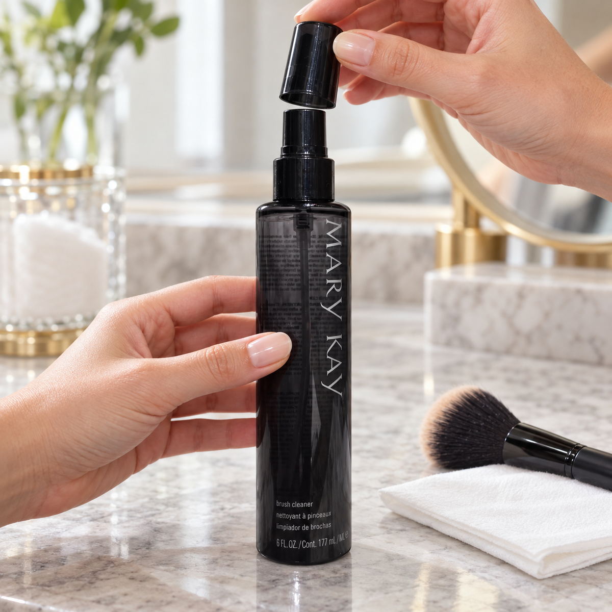 Removing the protective cap from a Mary Kay Brush Cleaner bottle before cleaning makeup brushes.