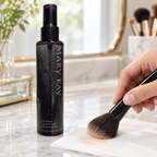 Sweeping makeup-brush bristles across a tissue beside a Mary Kay Brush Cleaner bottle.