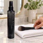 Laying a makeup brush flat on a towel to air-dry beside Mary Kay Brush Cleaner.