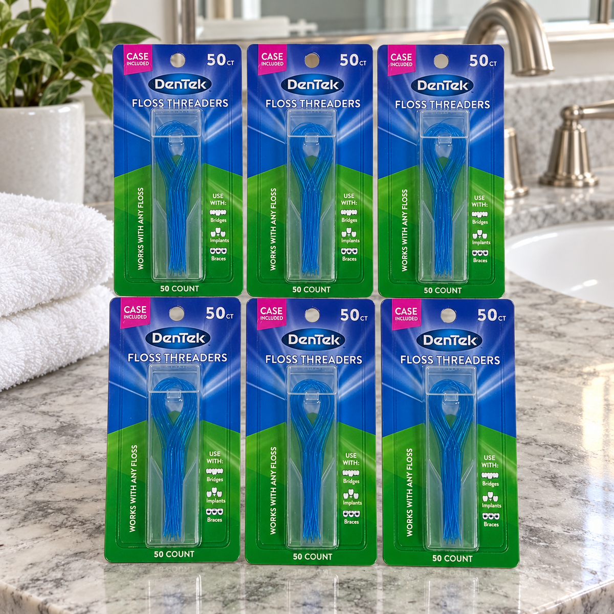 AI-generated lifestyle illustration of six DenTek Floss Threaders 50-count cards with their cases on a bathroom vanity beside towels; setting props not included.