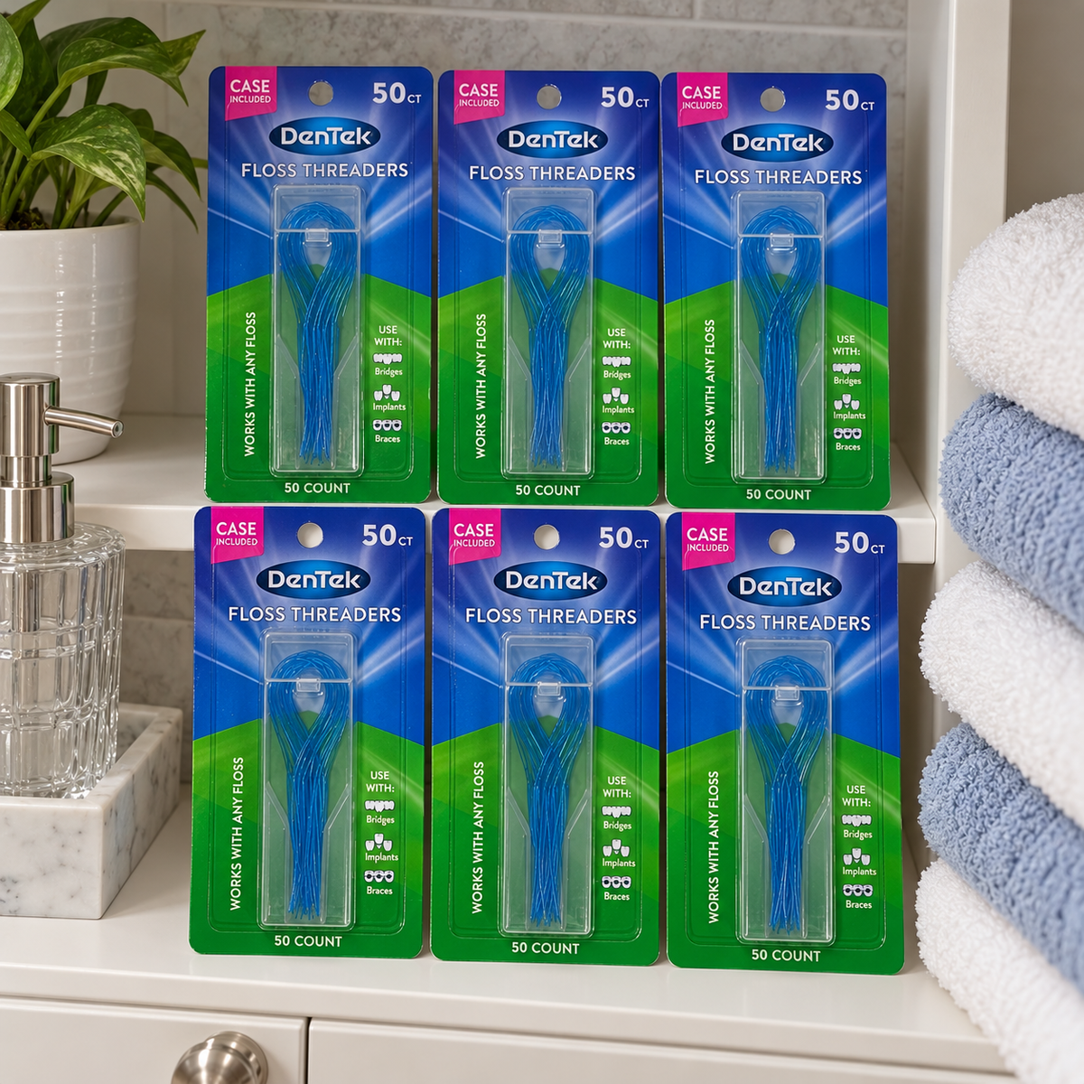 AI-generated lifestyle illustration of six DenTek Floss Threaders 50-count cards with their cases on a bathroom cabinet shelf beside folded towels; props not included.