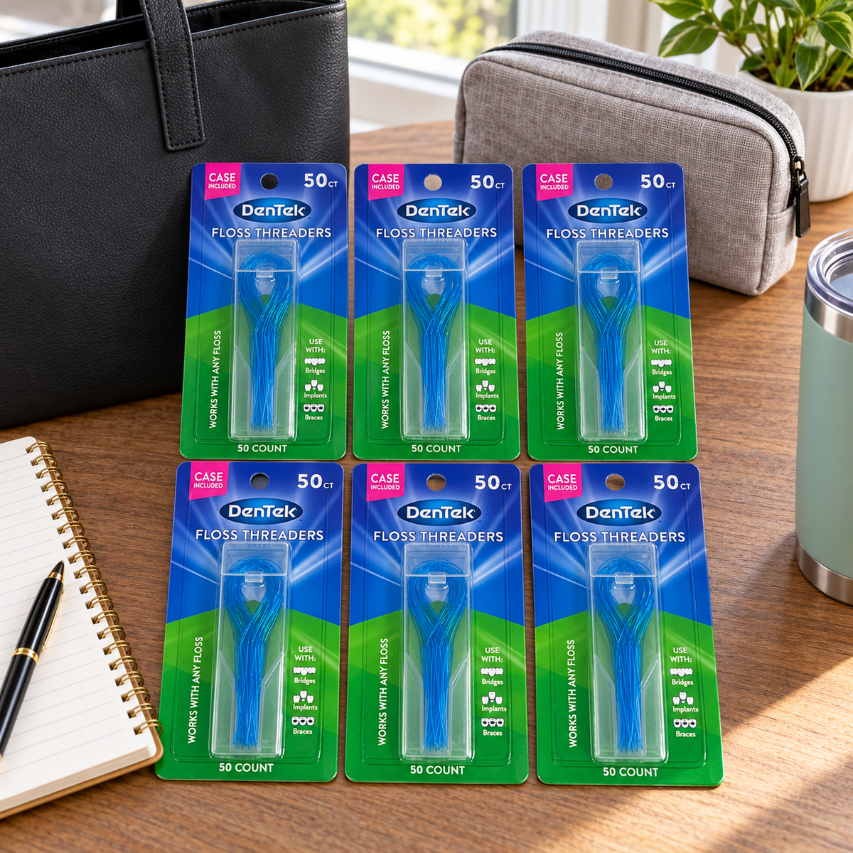 AI-generated lifestyle illustration of six DenTek Floss Threaders 50-count cards with their cases on a workday preparation table beside a tote and hygiene pouch; props not included.