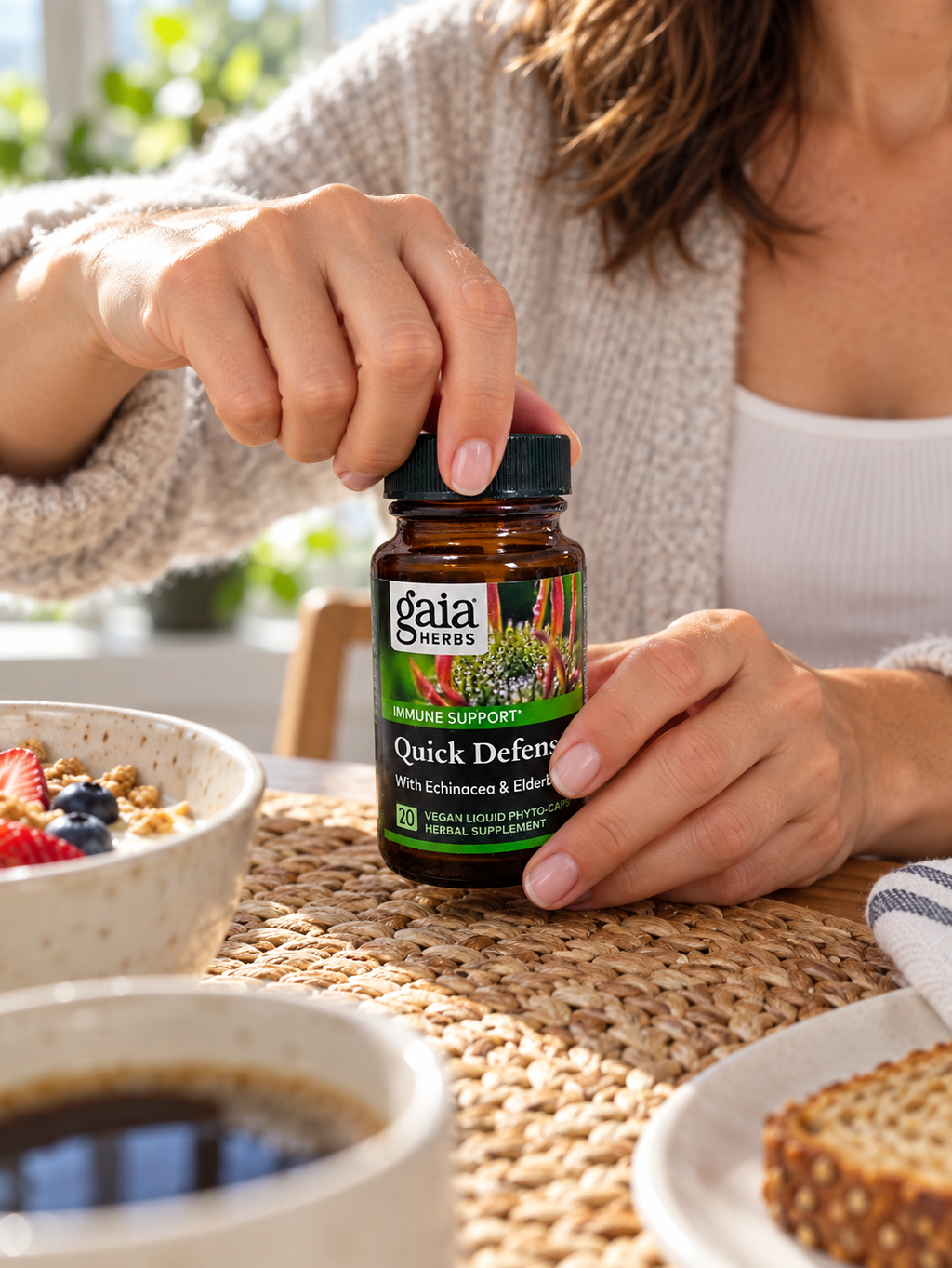 Opening a Gaia Herbs Quick Defense 20-capsule bottle.