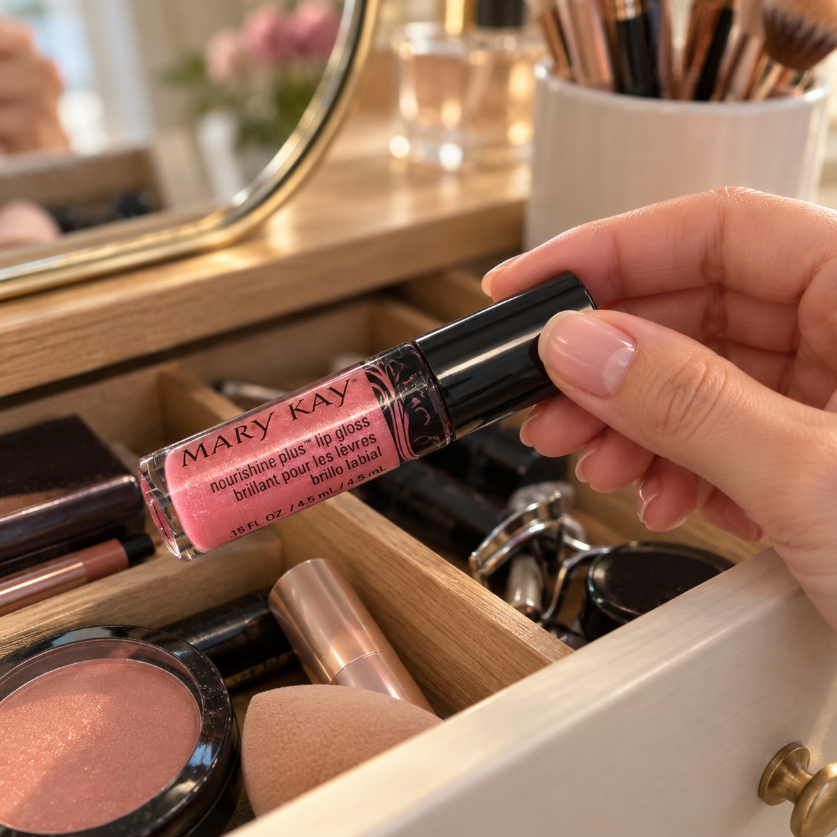 Choosing Pink Luster lip gloss from a vanity drawer
