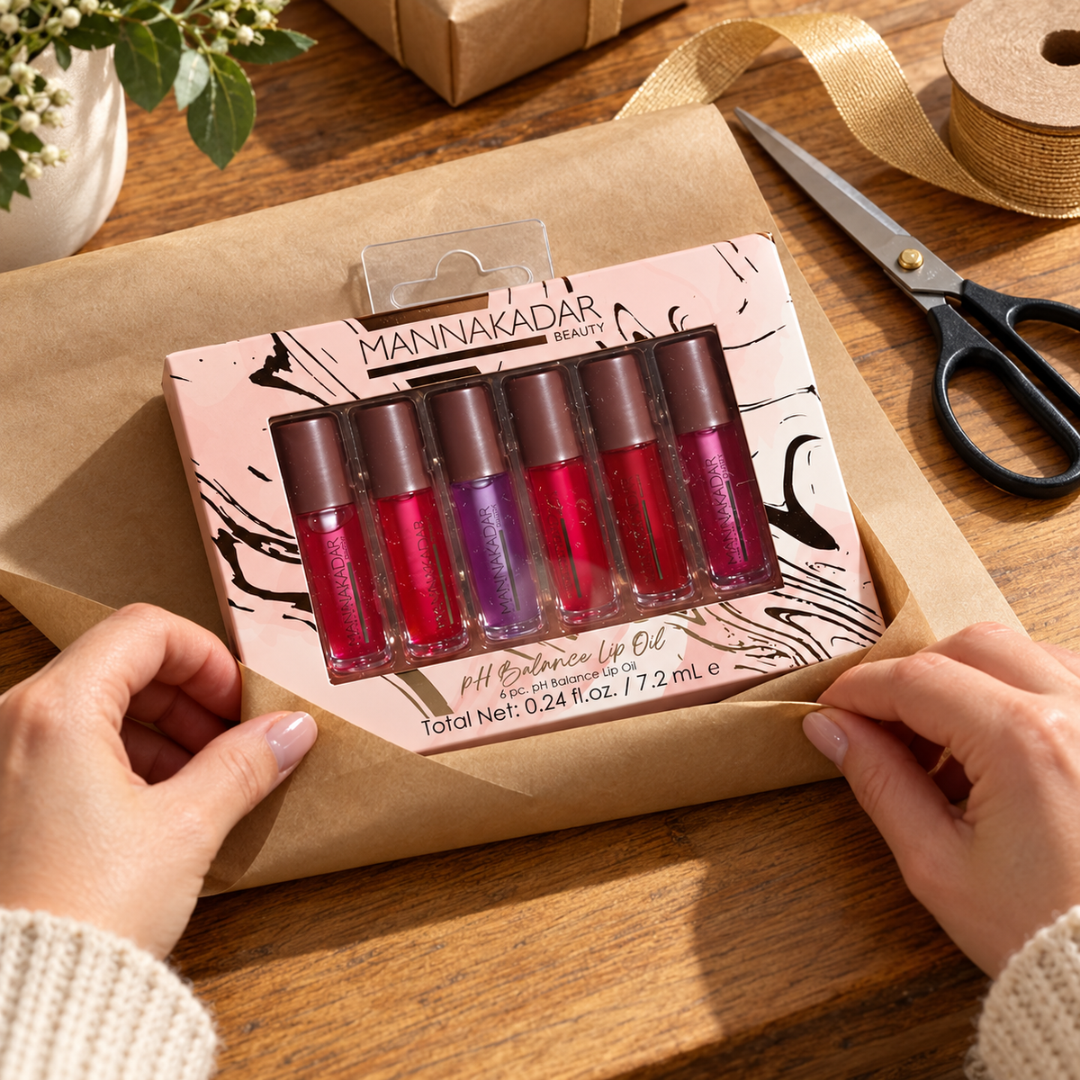 Manna Kadar six-piece pH Balance Lip Oil set being wrapped in kraft gift paper
