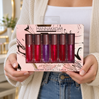 Manna Kadar six-piece pH Balance Lip Oil window box held with both hands