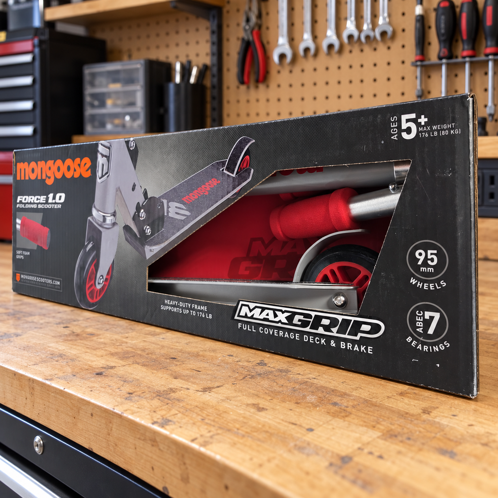Mongoose Force 1.0 red and silver scooter in original retail packaging, styled garage setting