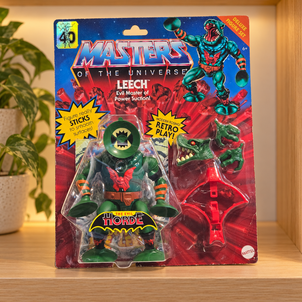 Mattel MOTU Origins Leech in original blister packaging, styled collector shelf setting