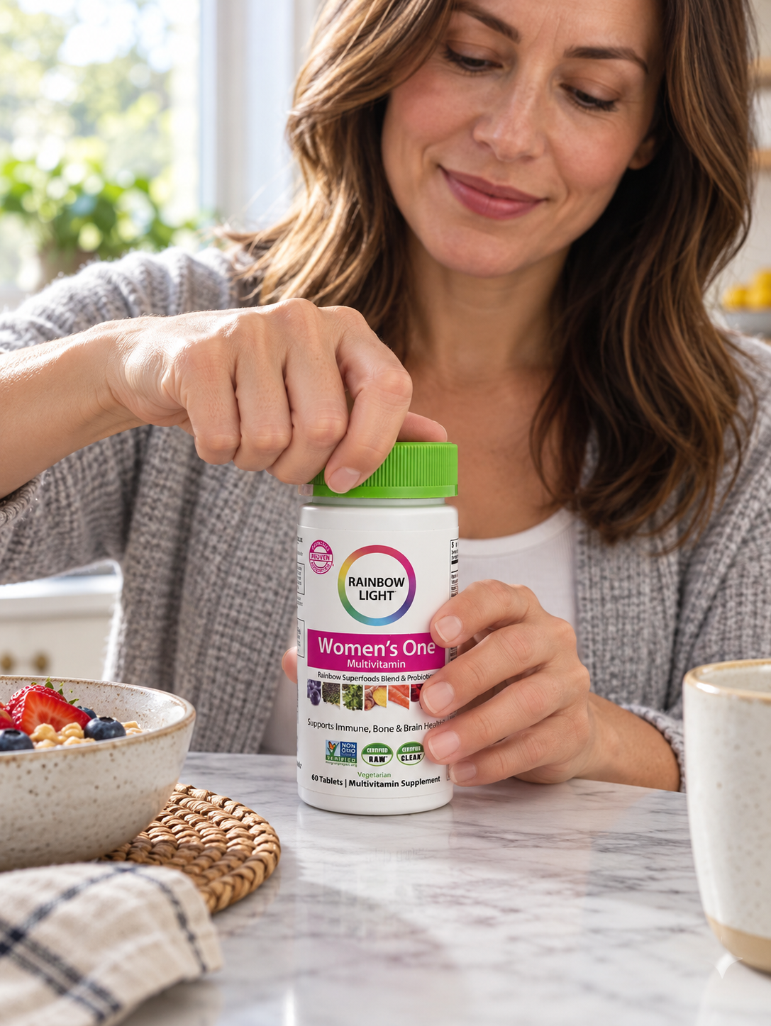 Opening a Rainbow Light Women's One multivitamin bottle at breakfast.