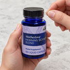 AI-generated illustration of adult hands peeling the clear cap band on a closed blue Motherlove Morning Sickness Blend 60-liquid-capsule bottle.