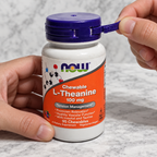 Opening the pull-tab seal on a NOW L-Theanine 100 mg bottle