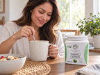 Stirring a drink beside Sunwarrior Thermo Greens Green Apple powder.