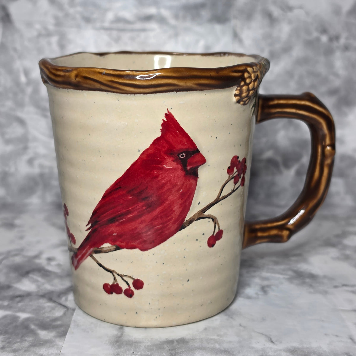 St. Nicholas Square Snow Valley mug with red cardinal, winter berries and brown branch-style handle