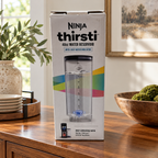 AI-generated lifestyle illustration of one boxed Ninja Thirsti 48 oz water reservoir on a dining buffet. Background props not included.