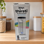 Boxed Ninja Thirsti 48 oz reservoir on a pantry counter; AI-generated lifestyle illustration.