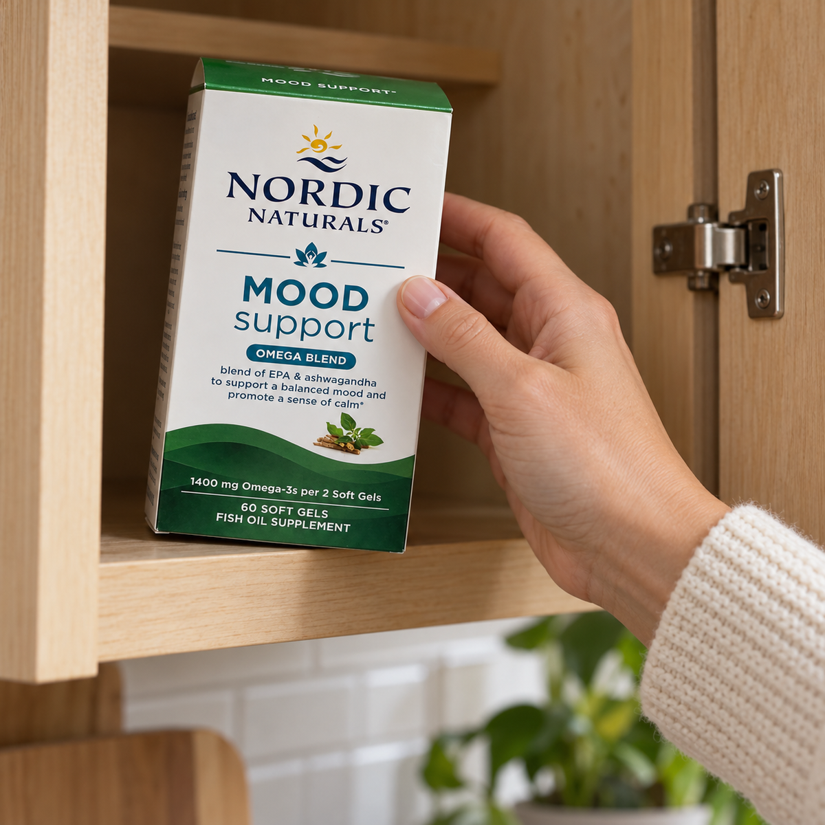 Taking a Nordic Naturals Mood Support carton from a kitchen cabinet