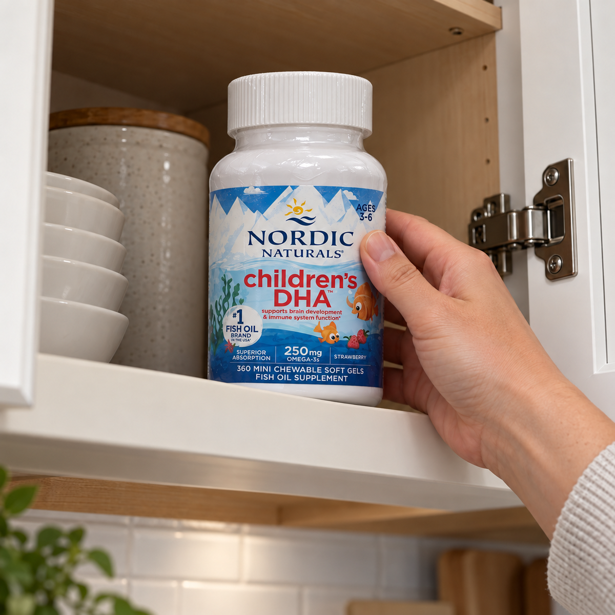 Adult placing a closed Nordic Naturals Children's DHA bottle in an upper cupboard